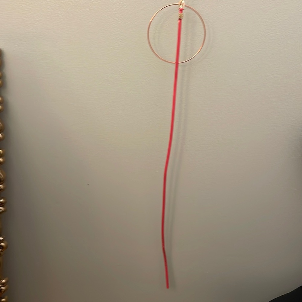 New gold-detailed, shiny pink belt; 43 inch long; .25 inches wide